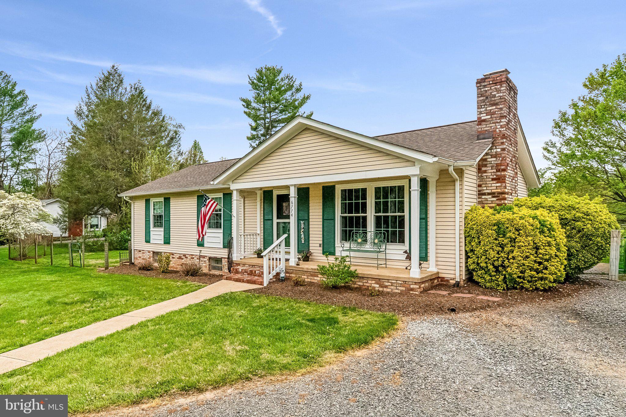 a front view of a house with garden and porch