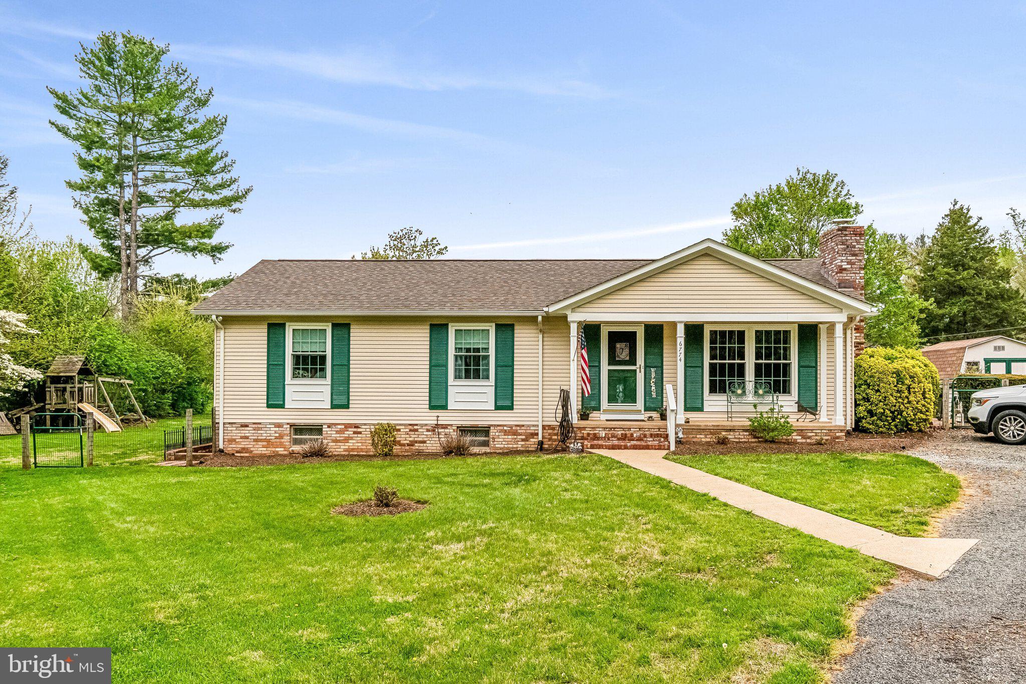 6774 Grays Mill Road Warrenton, VA 20187 - Photo 2 of 35 a front view of a house with a yard and porch