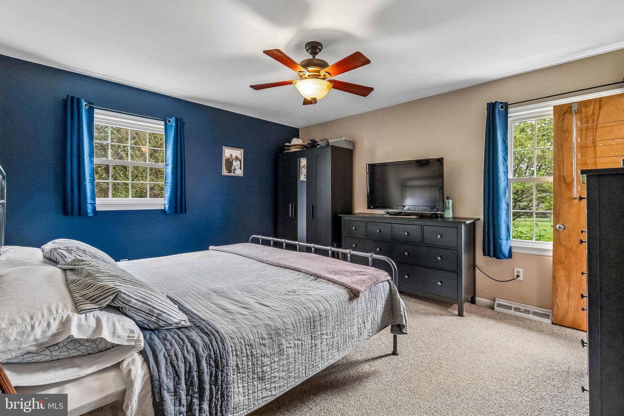 6774 Grays Mill Road Warrenton, VA 20187 - Photo 24 of 35 a bedroom with a bed and a flat screen tv