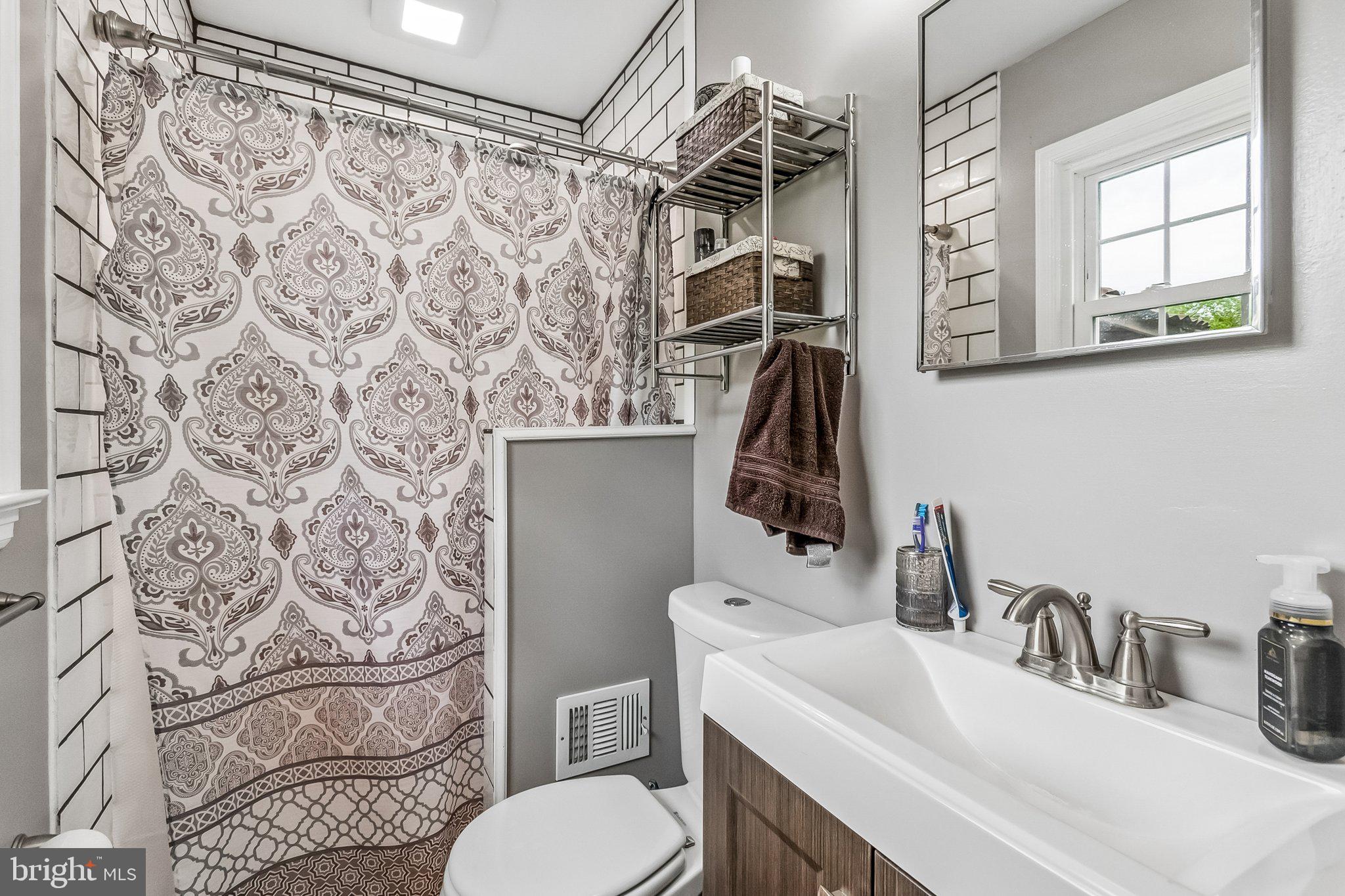 6774 Grays Mill Road Warrenton, VA 20187 - Photo 25 of 35 a bathroom with a sink toilet and shower