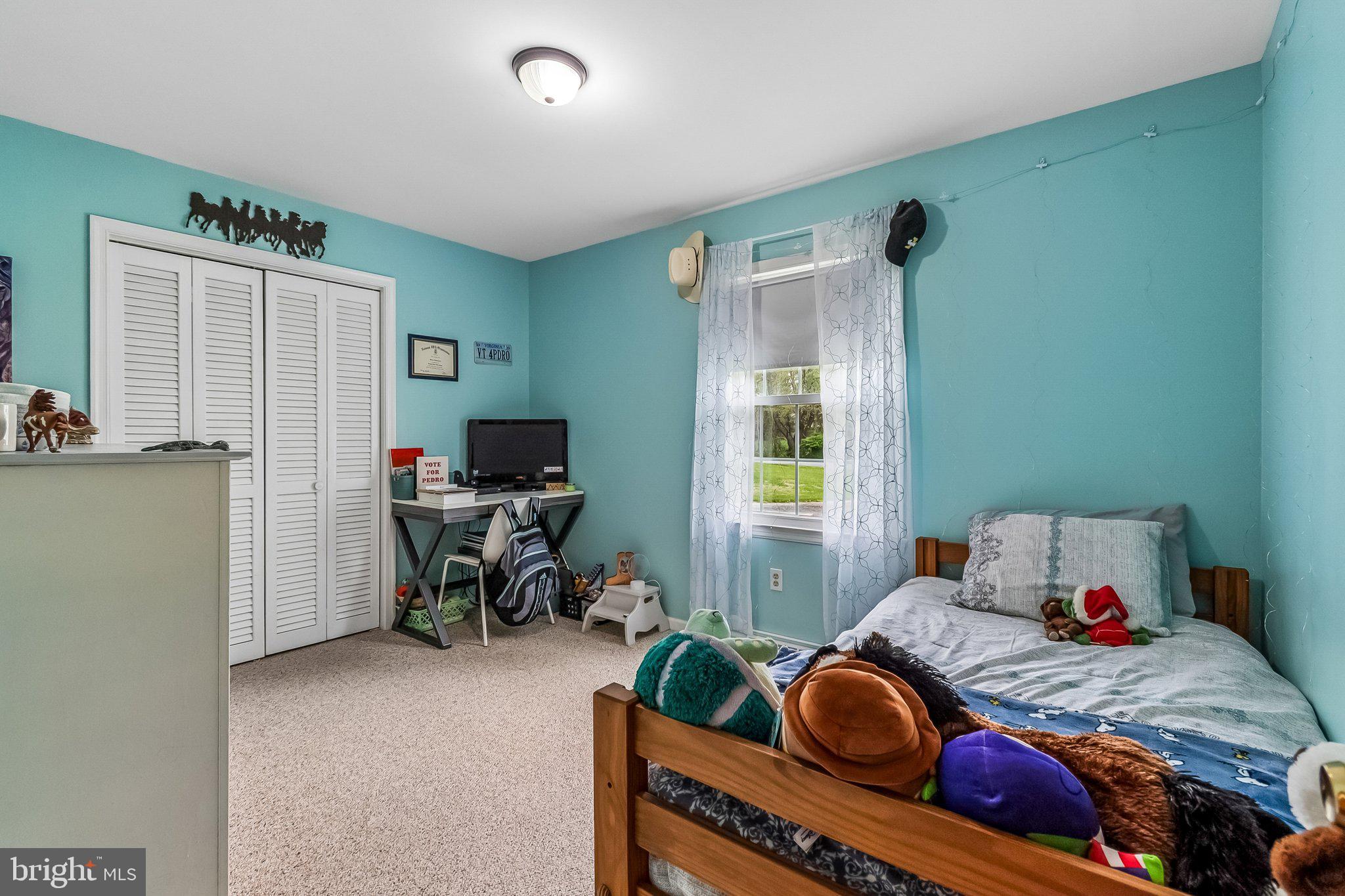 6774 Grays Mill Road Warrenton, VA 20187 - Photo 27 of 35 a bedroom with a bed and a chair
