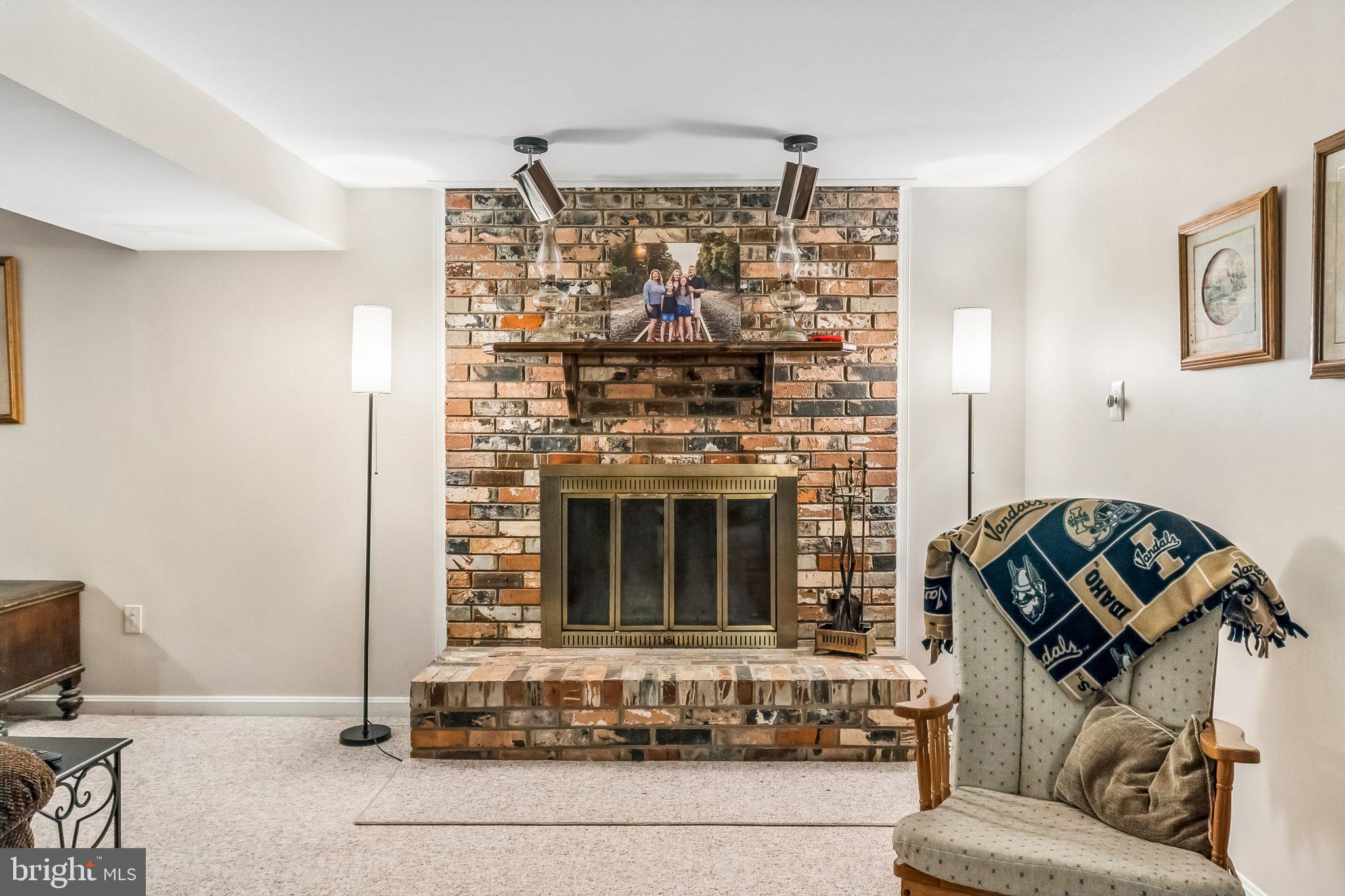 6774 Grays Mill Road Warrenton, VA 20187 - Photo 29 of 35 a living room with furniture and a fireplace
