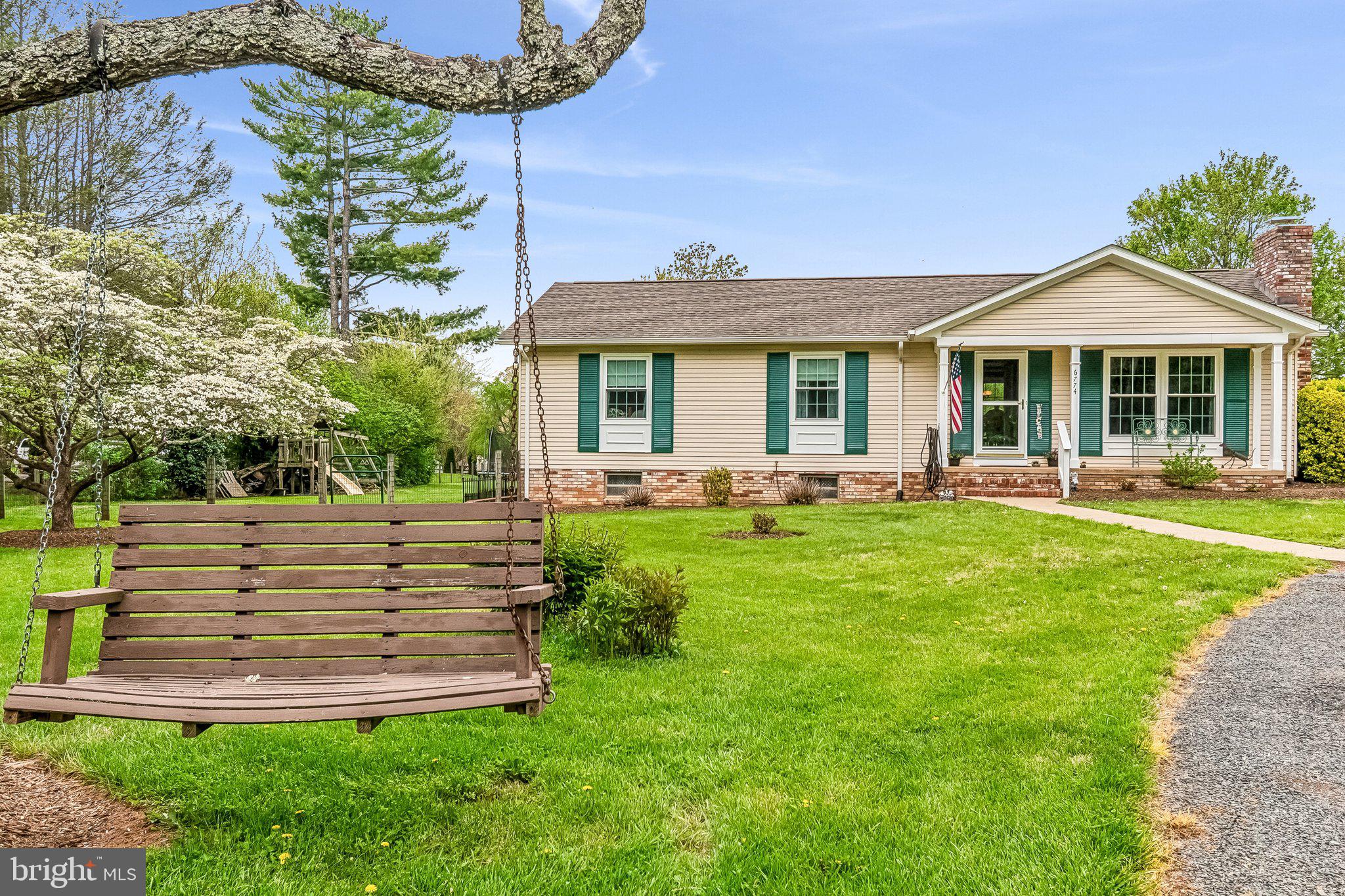 6774 Grays Mill Road Warrenton, VA 20187 - Photo 3 of 35 a front view of a house with a yard table and chairs