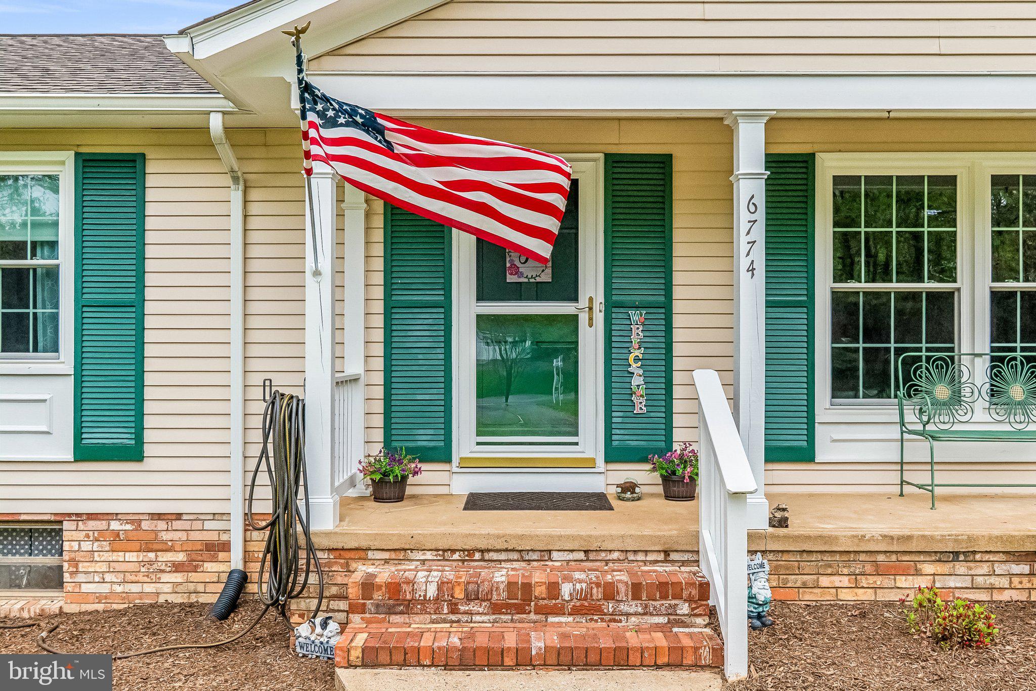 6774 Grays Mill Road Warrenton, VA 20187 - Photo 5 of 35 a front view of a house with a yard