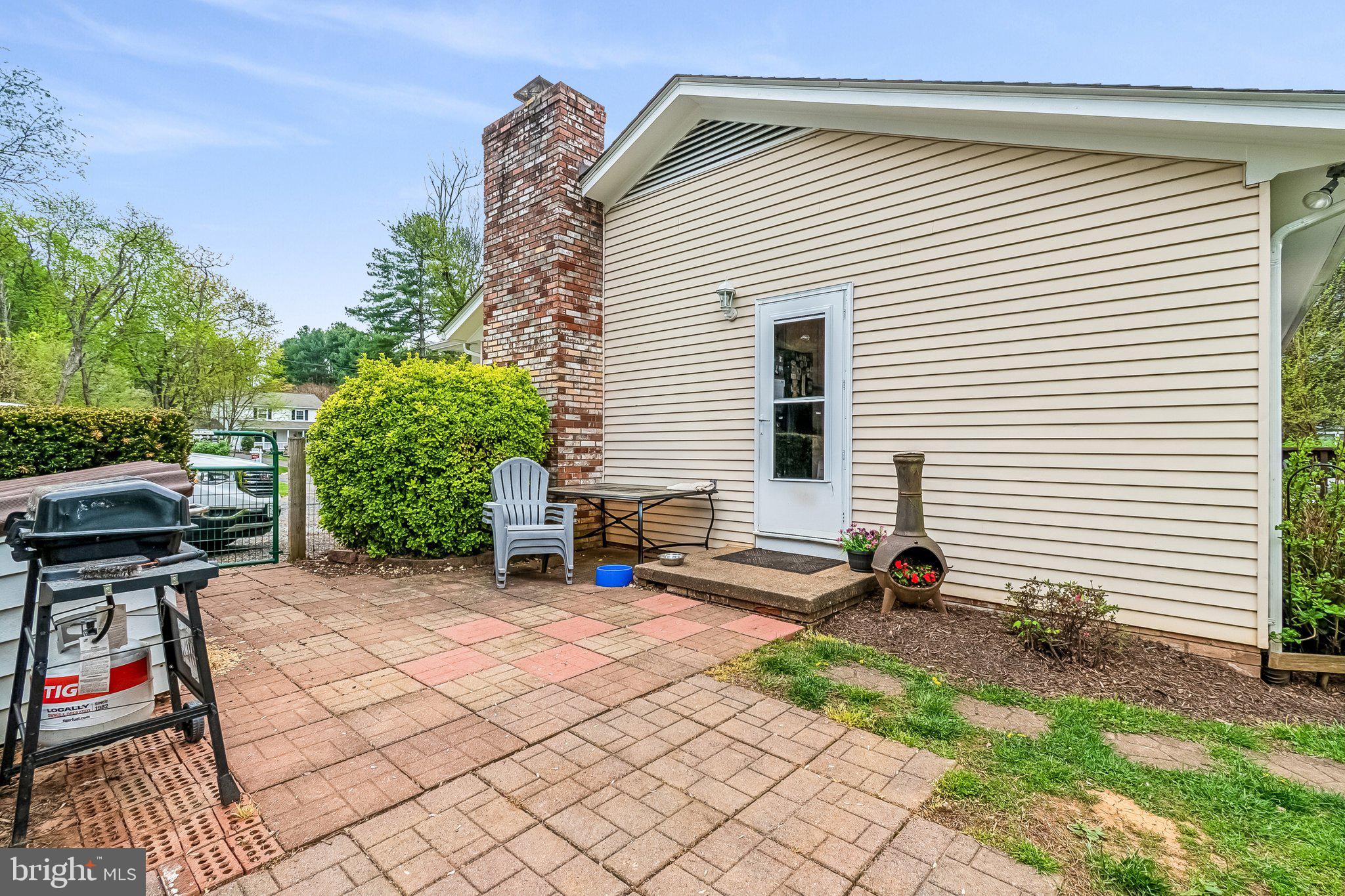 6774 Grays Mill Road Warrenton, VA 20187 - Photo 6 of 35 a view of backyard with a table and a chairs