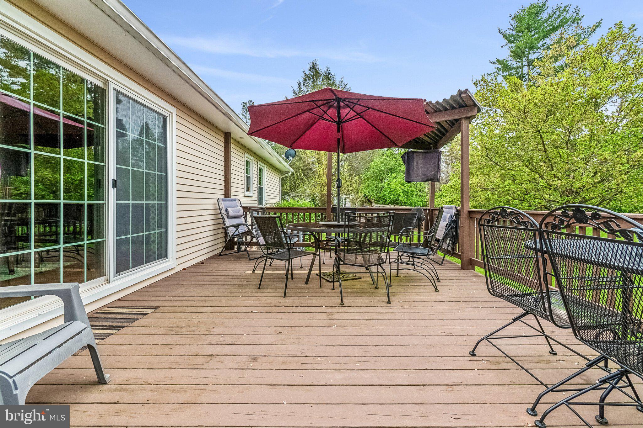 6774 Grays Mill Road Warrenton, VA 20187 - Photo 7 of 35 a view of a house with wooden deck and furniture