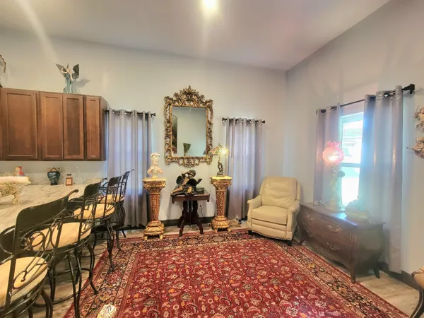 a large kitchen with stainless steel appliances kitchen island granite countertop a refrigerator and a stove top oven