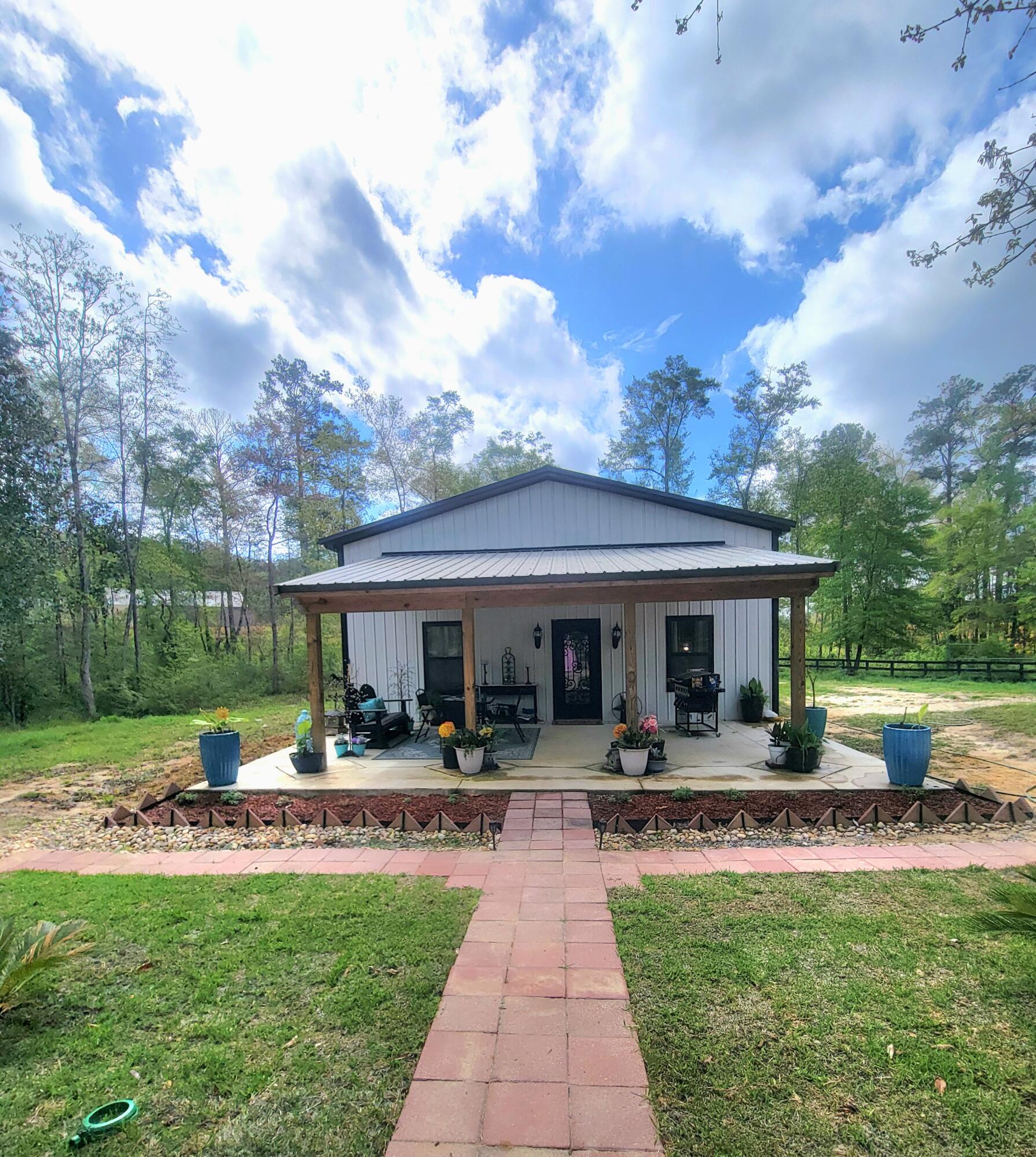 1508 Crooked Creek Road Ponce de Leon, FL 32455 - Photo 11 of 64 a view of a house with furniture and garden