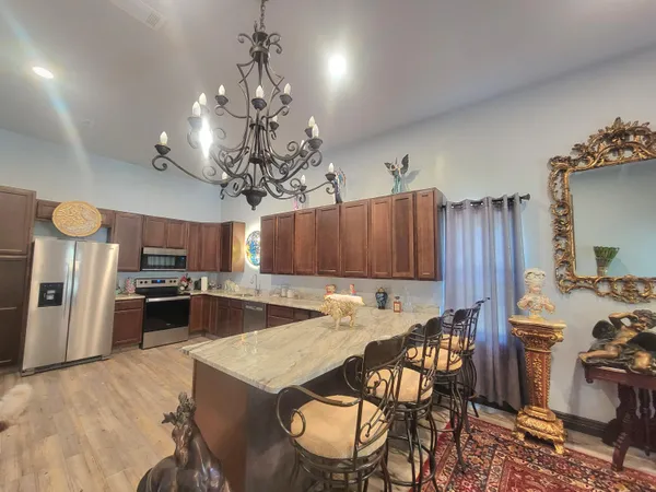 a living room with furniture and a chandelier