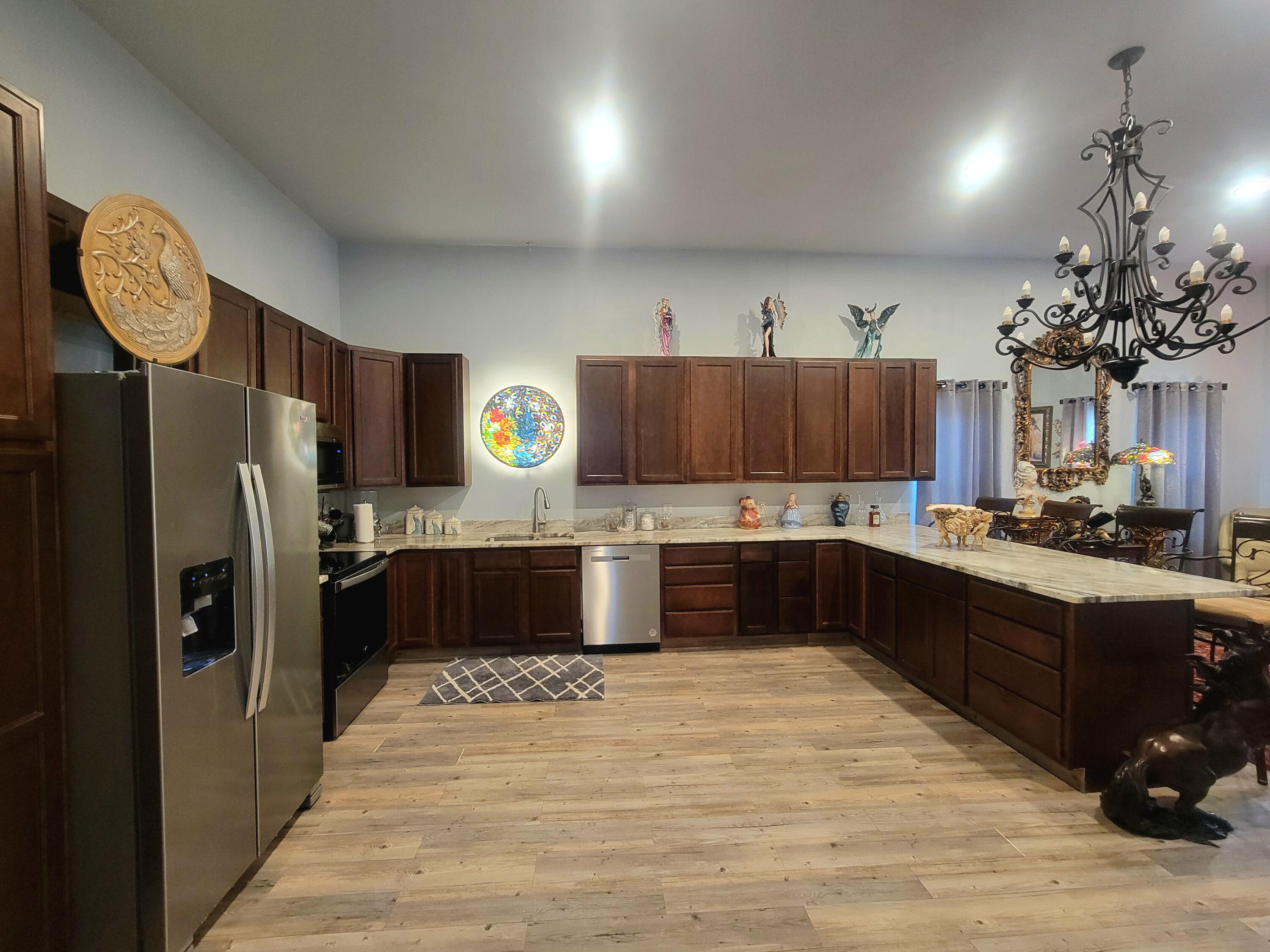 1508 Crooked Creek Road Ponce de Leon, FL 32455 - Photo 15 of 62 a large kitchen with stainless steel appliances kitchen island granite countertop a refrigerator and a stove top oven