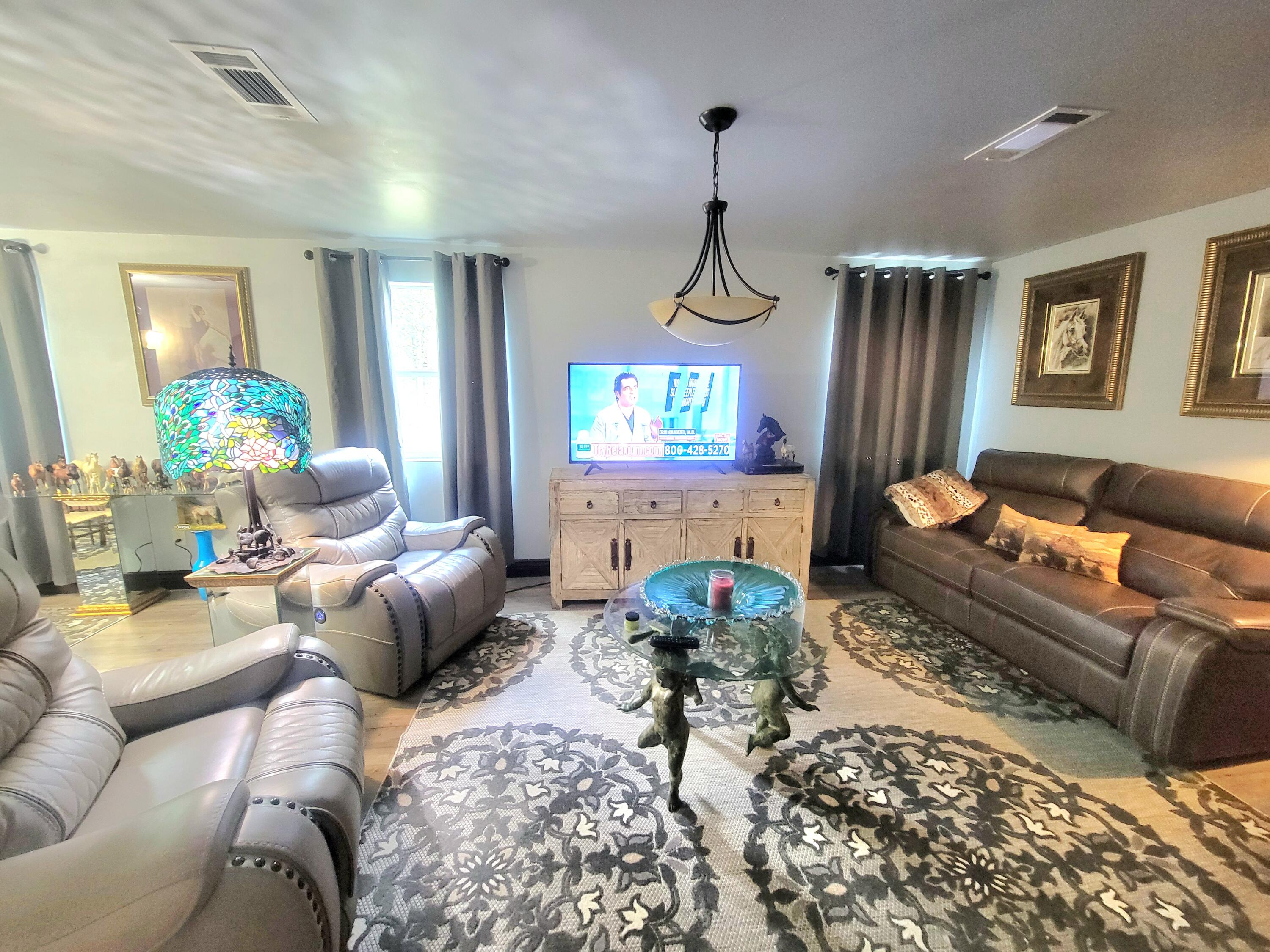 1508 Crooked Creek Road Ponce de Leon, FL 32455 - Photo 18 of 64 a living room with furniture and a chandelier