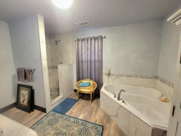 a bathroom with a granite countertop sink a mirror and shower