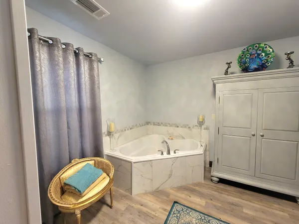 a bedroom with bed and a chandelier