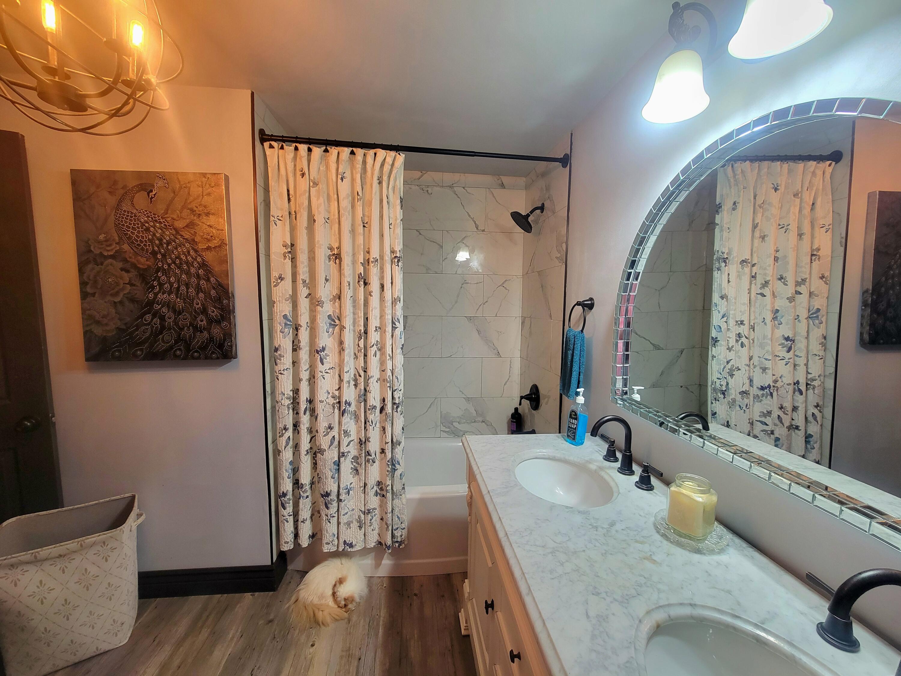 1508 Crooked Creek Road Ponce de Leon, FL 32455 - Photo 28 of 62 a bathroom with a granite countertop sink a mirror and shower