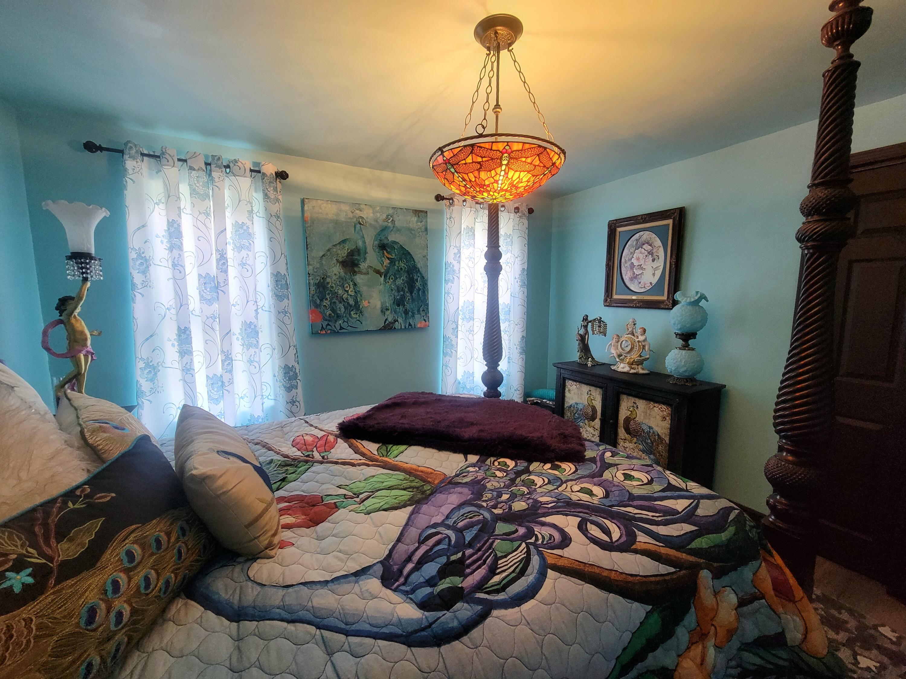 1508 Crooked Creek Road Ponce de Leon, FL 32455 - Photo 31 of 62 a bedroom with a bed and a chandelier