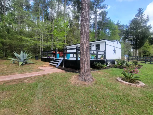 a view of a house with a yard and sitting area