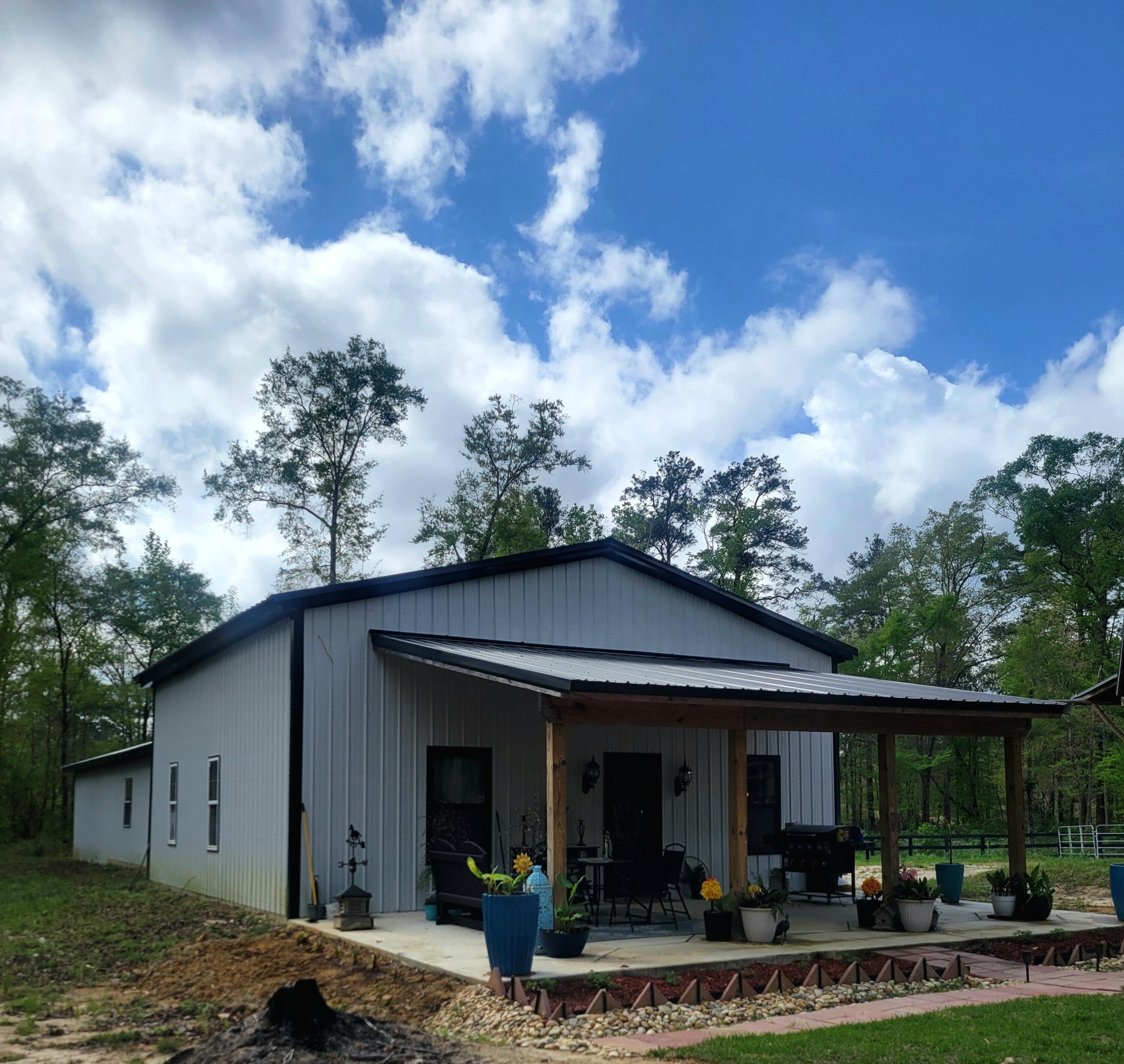 1508 Crooked Creek Road Ponce de Leon, FL 32455 - Photo 58 of 62 a view of a house that has a bunch of plants and trees
