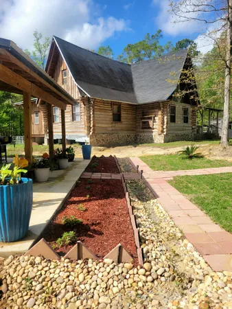 a view of a house with furniture and garden