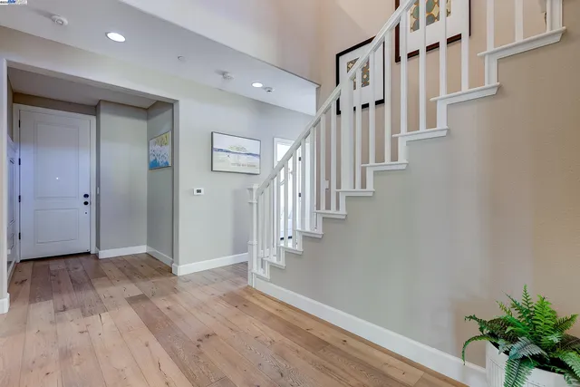 a view of entryway and hall with wooden floor