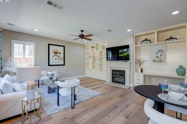 a living room with furniture a fireplace and a flat screen tv
