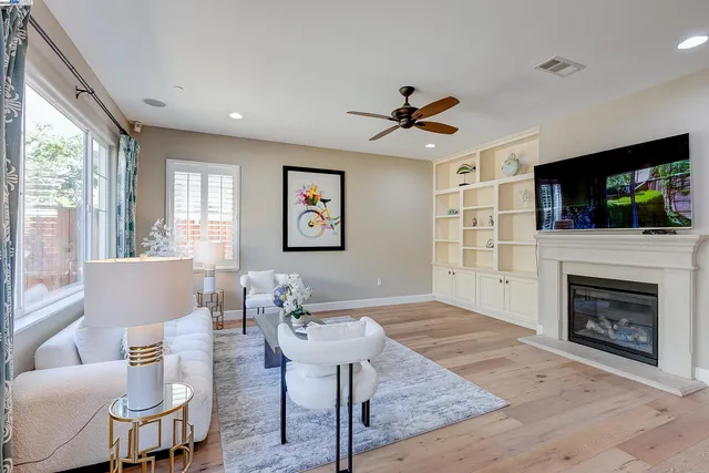 a kitchen with a table chairs refrigerator and cabinets