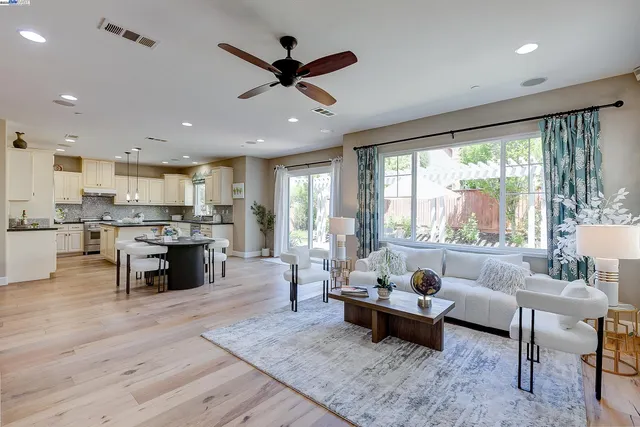 a kitchen with a refrigerator and a dining table