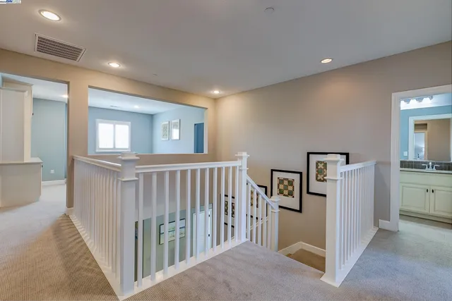 a bathroom with a toilet a sink a tub and a mirror