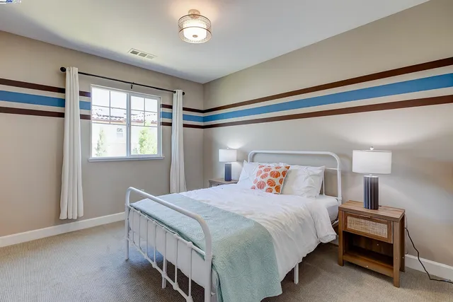 a white bath tub sitting in a bathroom and mirror