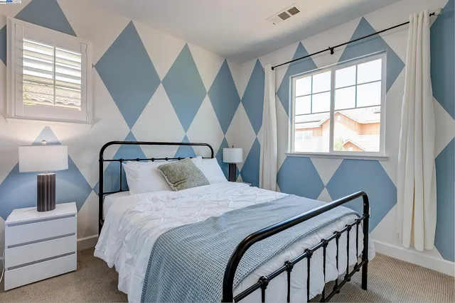 a spacious bathroom with a double vanity sink large mirror and a bathtub