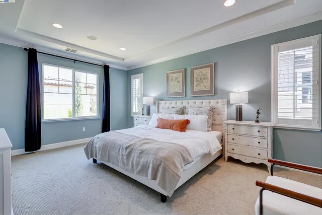a view of a patio with a table and chairs under an umbrella with palm trees