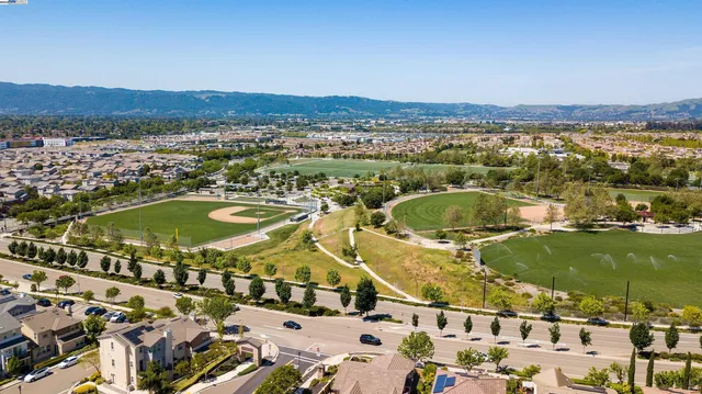 an aerial view of a residential houses with outdoor space