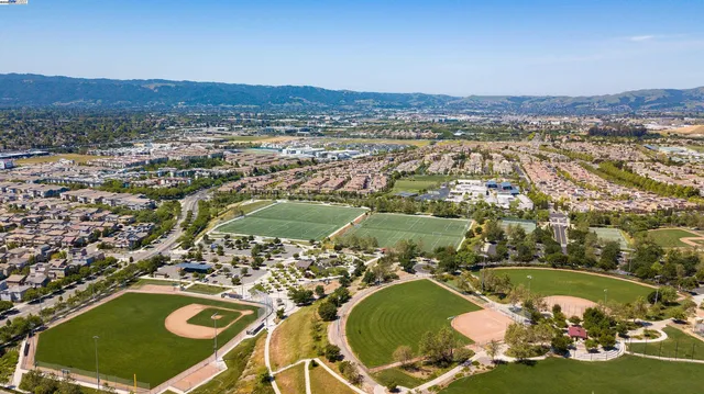 an aerial view of a residential houses with outdoor space