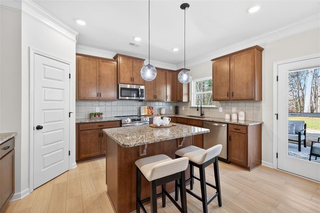 30 North Hvn Drive Rome, GA 30165 - Photo 14 of 38 a kitchen with stainless steel appliances granite countertop a kitchen island hardwood floor sink and stove