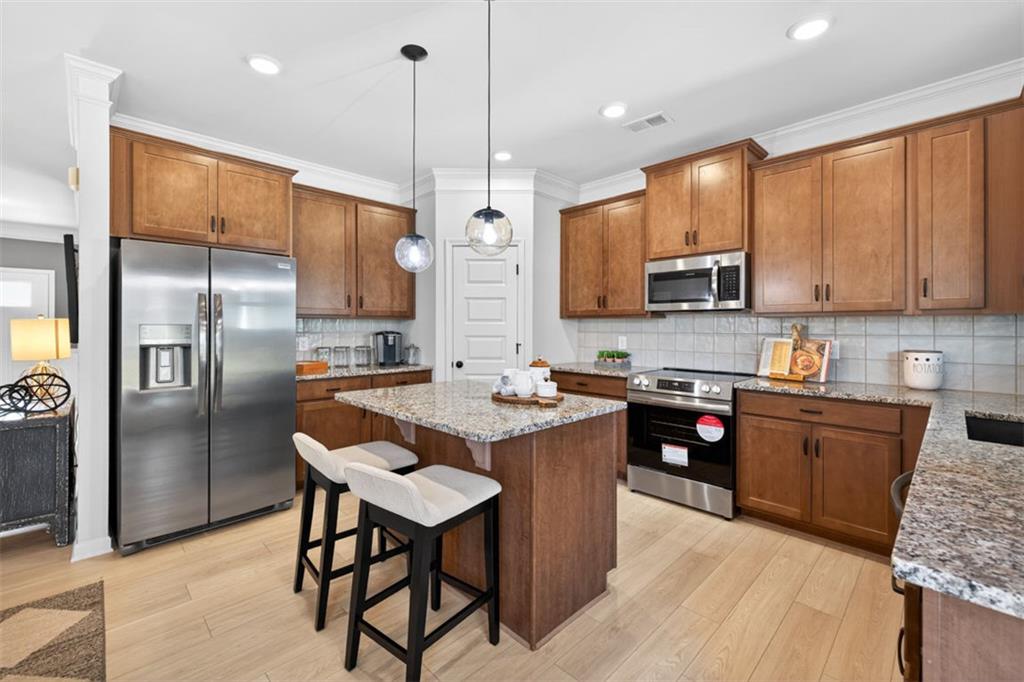 30 North Hvn Drive Rome, GA 30165 - Photo 15 of 38 a kitchen with stainless steel appliances granite countertop a refrigerator a stove a sink a dining table and chairs