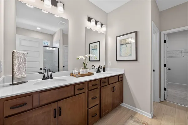 a bathroom with a double vanity sink and a mirror