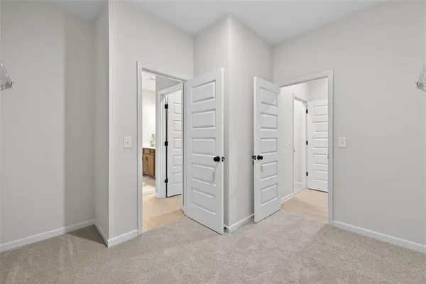 an empty room with closet and a bathroom