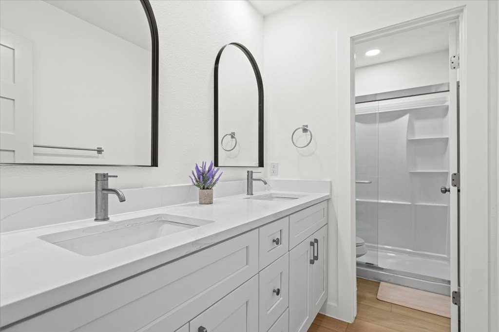 1406 North Georgetown Street Round Rock, TX 78664 - Photo 22 of 34 A well-appointed bathroom features a double vanity with ample storage and sleek, modern fixtures.