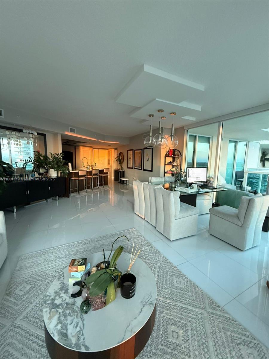 250 Sunny Isles Boulevard, Unit 31603 Sunny Isles Beach, FL 33160 - Photo 11 of 20 a living room with furniture and a kitchen view