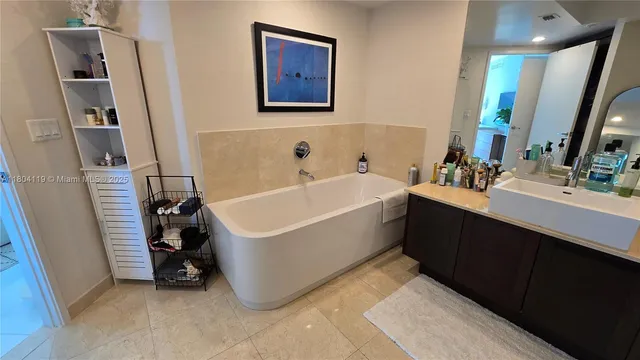 a bathroom with a bathtub a sink and a mirror