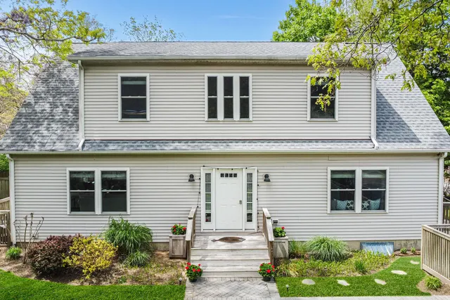 a view of a house with potted plants