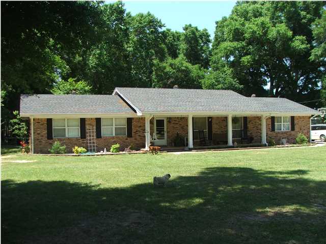 5102 Griffith Mill Road Holt, FL 32564 - Photo 1 of 12 a front view of a house with a garden