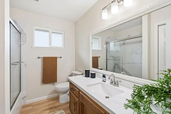 a living room with furniture a rug and a lamp