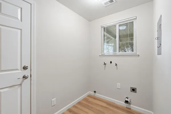 a kitchen with stainless steel appliances granite countertop a stove a sink dishwasher and cabinets with wooden floor