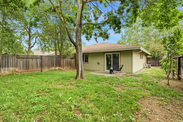 a kitchen with stainless steel appliances granite countertop a stove a sink dishwasher and a refrigerator with wooden cabinets