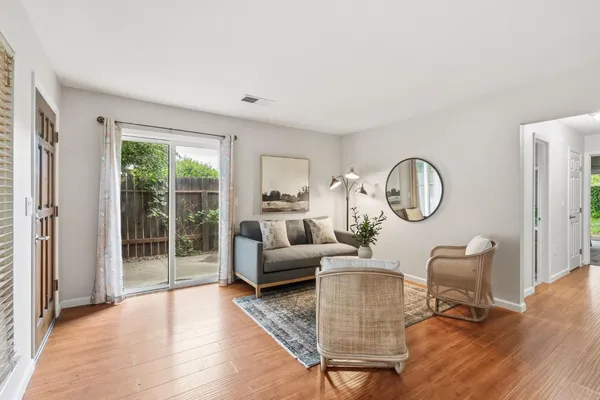 a kitchen with a refrigerator a stove a dining table and chairs