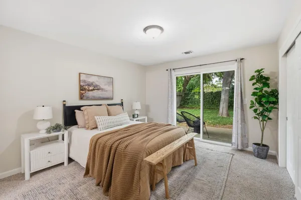 a view of a house with backyard and a tree