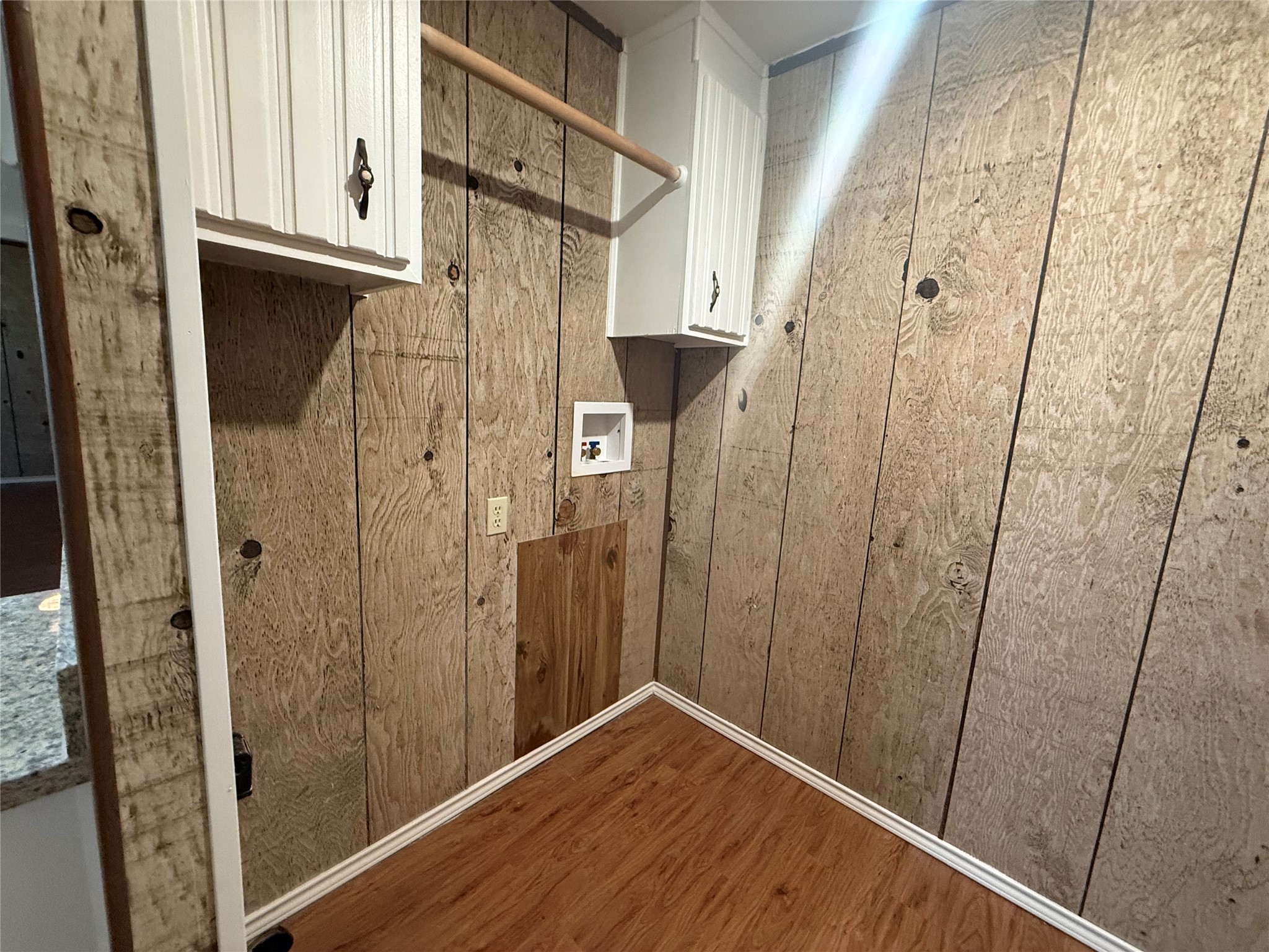23393 Nameless Road, Unit 112 Leander, TX 78641 - Photo 12 of 16 Warm wood paneling and dedicated utility hookups define this functional laundry space.
