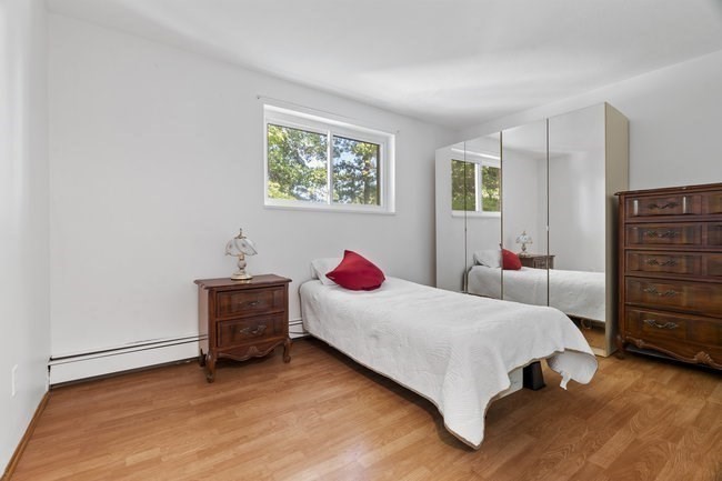 357 Faneuil Street, Unit 12 Boston, MA 02135 - Photo 12 of 15 a bedroom with a bed and dresser