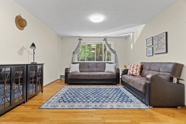357 Faneuil Street, Unit 12 Boston, MA 02135 - Photo 3 of 15 a living room with furniture and a rug