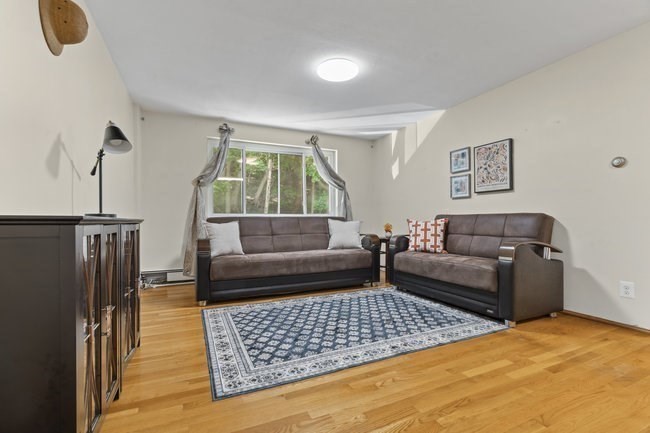 357 Faneuil Street, Unit 12 Boston, MA 02135 - Photo 4 of 15 a living room with furniture and a rug